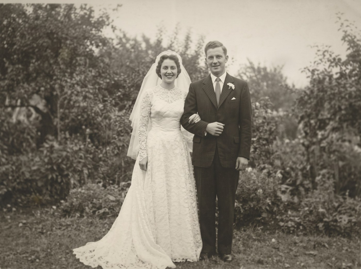 The same wedding photograph after our repair: the dust, the spots, the crease and the scratches gone, the print even and clean.