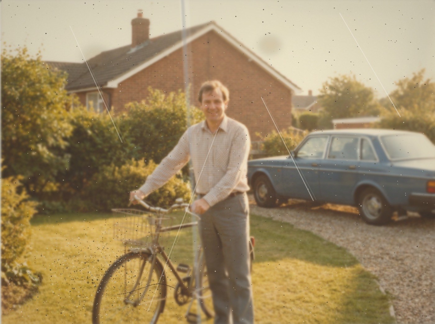 A photograph in the style of a 1985 colour print, faded and softened, with dust, speckling, brown age spots and scratch lines across it.