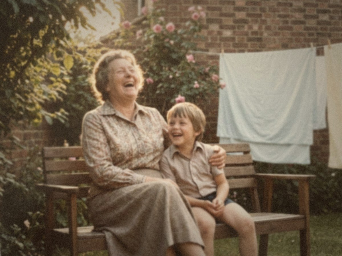 A colour photograph from 1978 of a grandmother laughing on a garden bench with her young grandson sitting beside her.